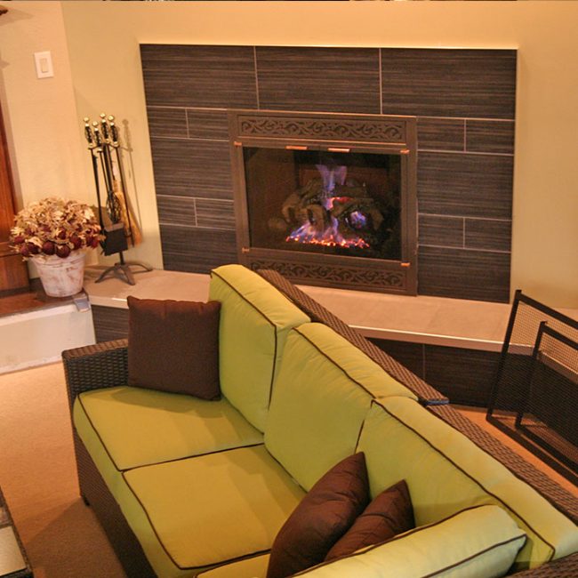 green sofa along with a fireplace in monticello ia